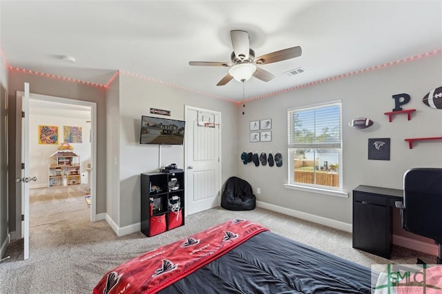 bedroom with baseboards, a ceiling fan, visible vents, and light colored carpet