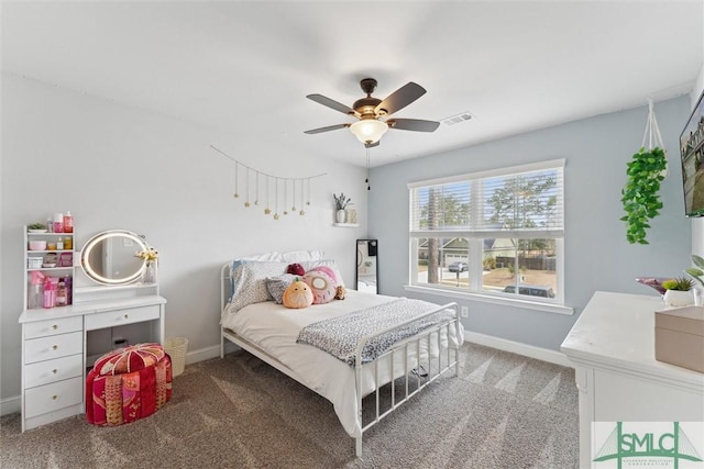 bedroom featuring baseboards, visible vents, ceiling fan, and light colored carpet