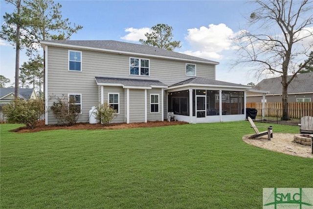 back of house with a sunroom, fence, and a yard