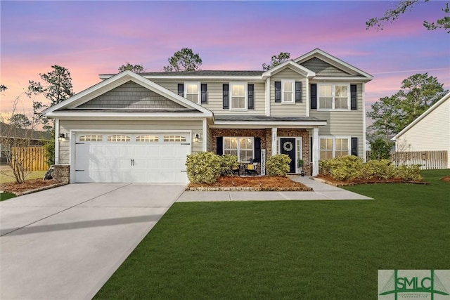 view of front facade with concrete driveway, a front lawn, an attached garage, and fence