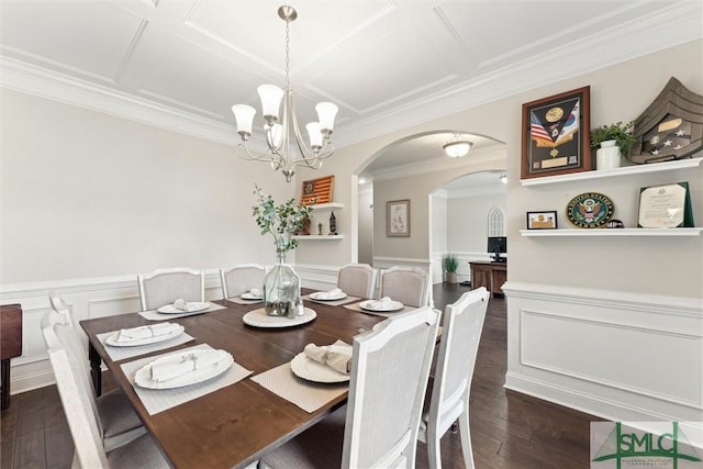 dining room with dark wood-style floors, arched walkways, a wainscoted wall, ornamental molding, and coffered ceiling