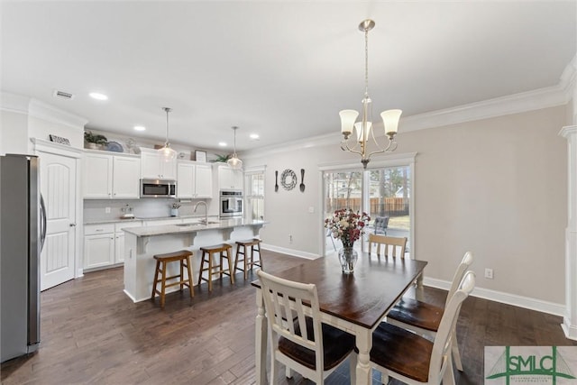 dining area with baseboards, visible vents, dark wood-style flooring, and crown molding