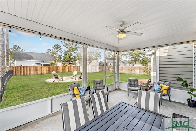 sunroom featuring a ceiling fan and plenty of natural light