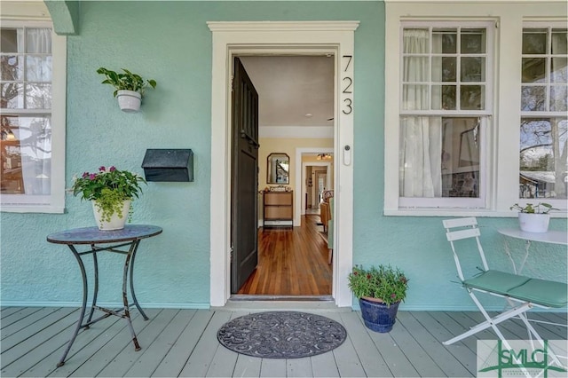 property entrance with stucco siding