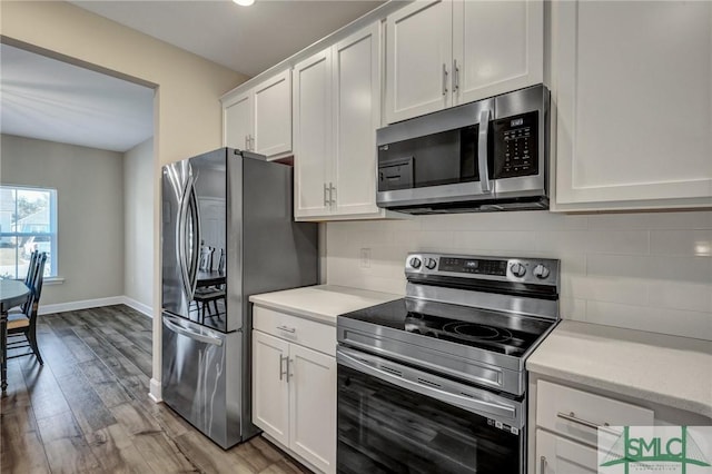 kitchen featuring white cabinets, tasteful backsplash, appliances with stainless steel finishes, and light countertops