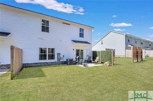 rear view of property featuring a lawn, a patio area, fence, and central air condition unit