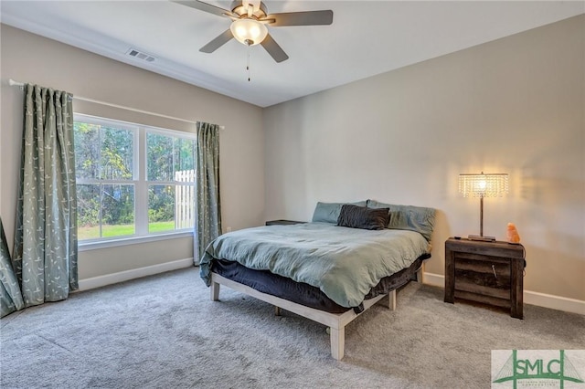 carpeted bedroom featuring visible vents, ceiling fan, and baseboards