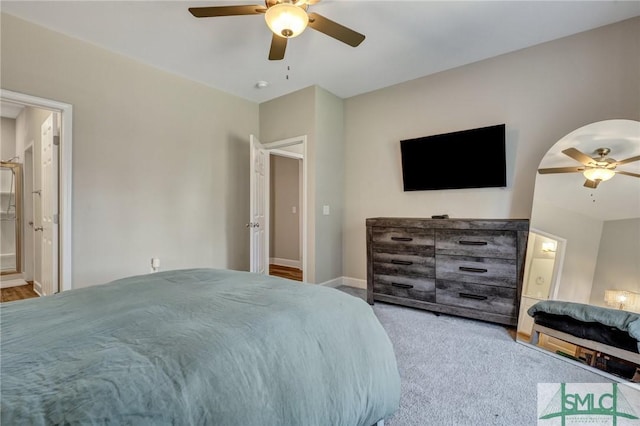 bedroom with ensuite bath, baseboards, a ceiling fan, and carpet flooring