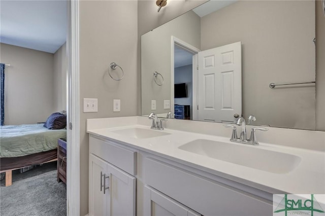 full bath featuring double vanity, connected bathroom, and a sink