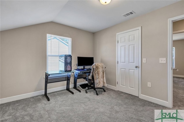 office space with baseboards, visible vents, vaulted ceiling, and carpet flooring