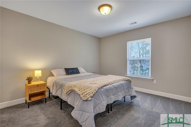 bedroom featuring visible vents, dark carpet, and baseboards