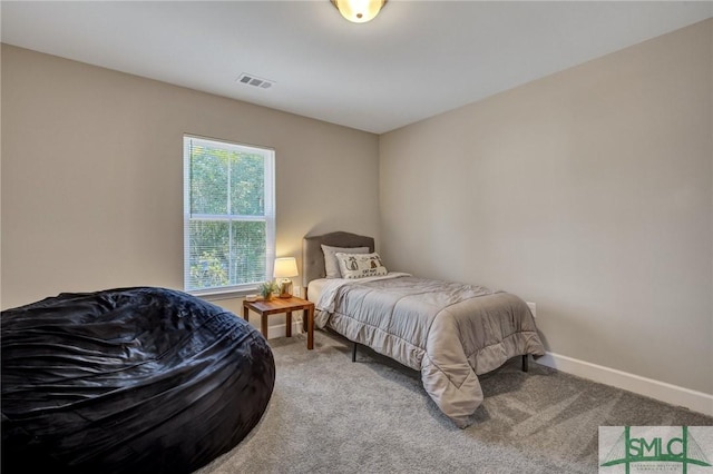 carpeted bedroom featuring visible vents and baseboards