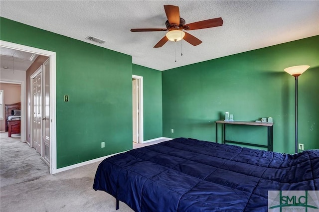 bedroom featuring visible vents, attic access, carpet flooring, a textured ceiling, and baseboards