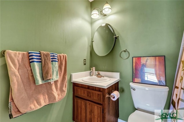 bathroom with toilet and vanity