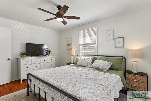 bedroom featuring ceiling fan, ornamental molding, and wood finished floors