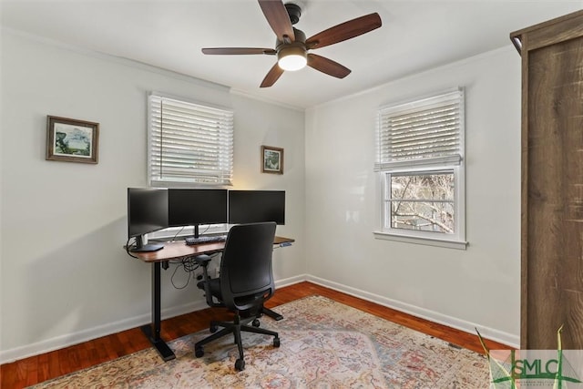 home office featuring crown molding, baseboards, and wood finished floors