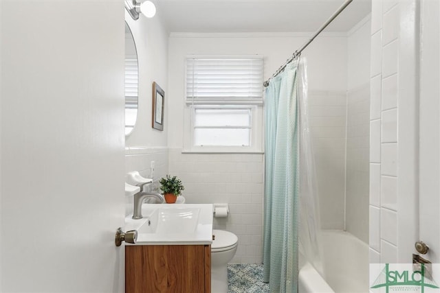 full bathroom featuring toilet, ornamental molding, shower / bath combo with shower curtain, vanity, and tile walls