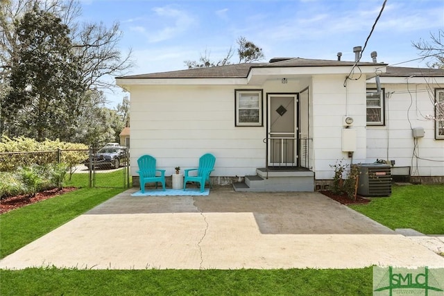 rear view of house featuring a patio area, a gate, fence, and cooling unit