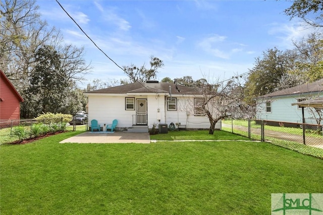 rear view of house featuring a patio area, a fenced backyard, cooling unit, and a yard