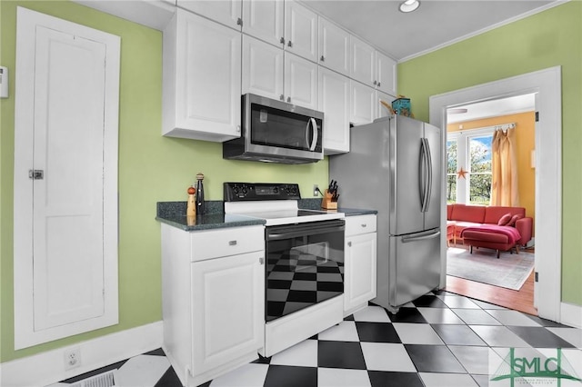 kitchen with stainless steel appliances, white cabinets, crown molding, and tile patterned floors