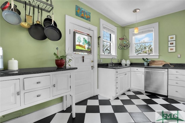 kitchen with dark floors, white cabinetry, dishwasher, and dark countertops