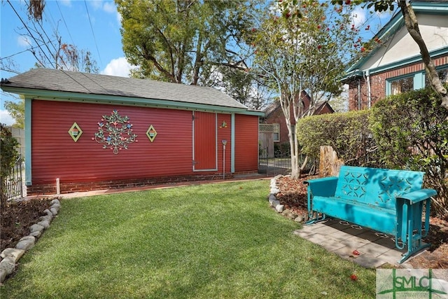 view of yard with fence and an outdoor structure