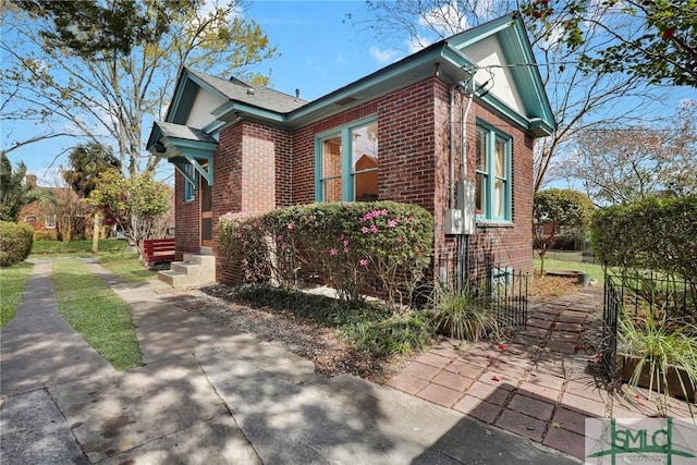 view of property exterior with brick siding