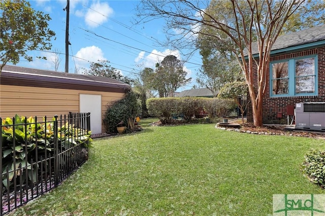 view of yard with fence and central air condition unit