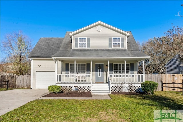 view of front of property with concrete driveway, fence, covered porch, and a front yard