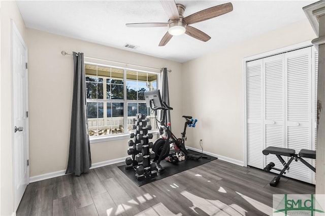 exercise area featuring ceiling fan, wood finished floors, visible vents, and baseboards