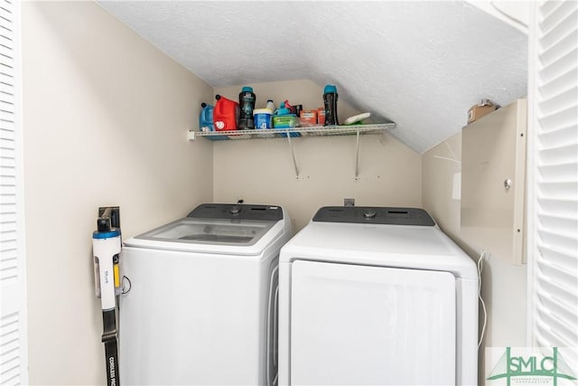 laundry area with a textured ceiling, laundry area, and washer and clothes dryer