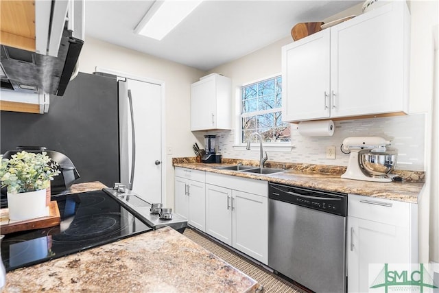 kitchen with a sink, light stone counters, tasteful backsplash, white cabinetry, and dishwasher