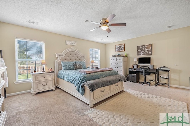 bedroom featuring baseboards, ceiling fan, visible vents, and light colored carpet