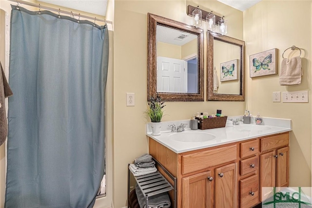 bathroom with shower / bath combination with curtain, visible vents, a sink, and double vanity