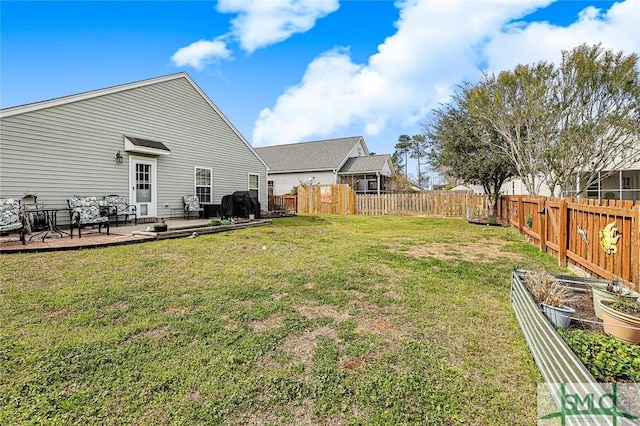 view of yard featuring a fenced backyard and a vegetable garden