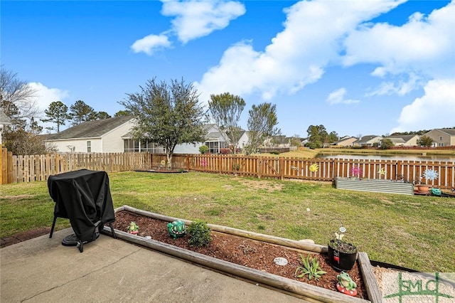 view of yard with a residential view, a fenced backyard, and a patio