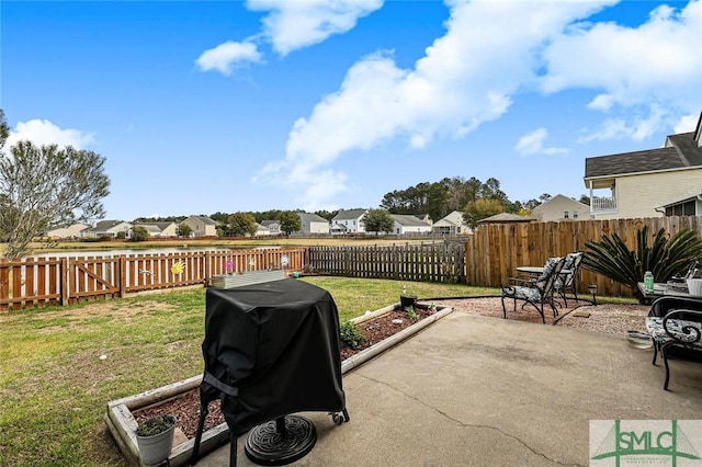 view of patio with area for grilling, a fenced backyard, and a residential view