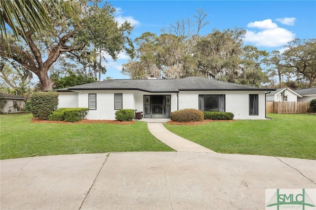 ranch-style house with fence, a front lawn, and stucco siding