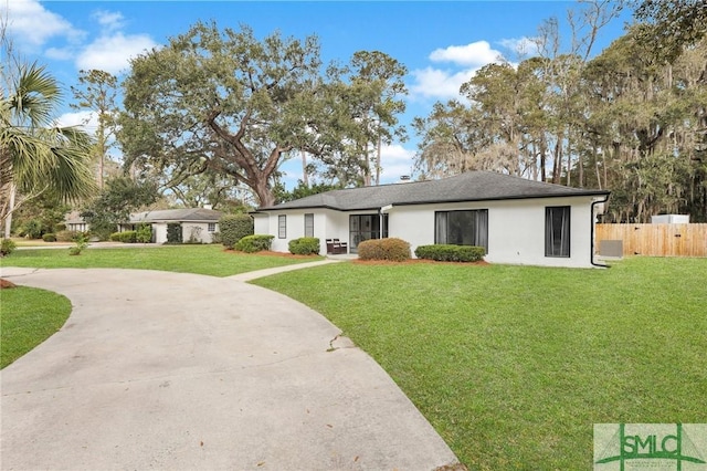 ranch-style home with concrete driveway, a front lawn, fence, and stucco siding