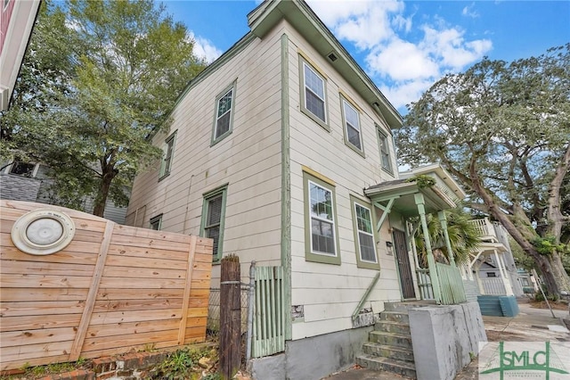 view of home's exterior with fence