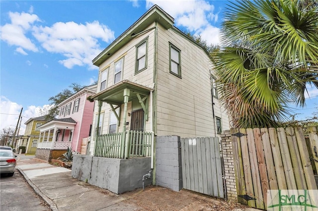 view of side of property with a gate and fence