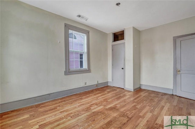 unfurnished bedroom with light wood-type flooring and visible vents