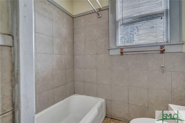 bathroom featuring toilet, tile walls, a shower, and a bath