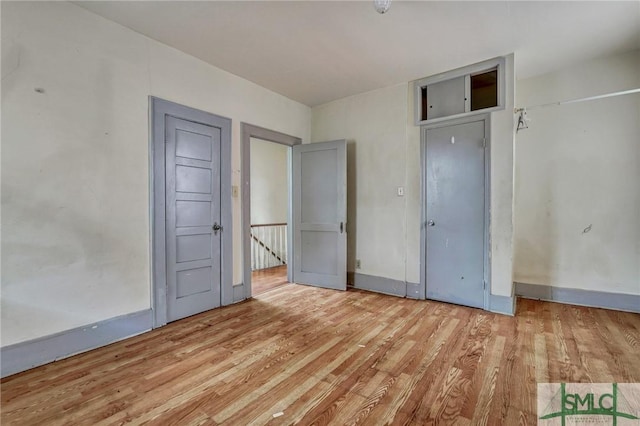 unfurnished bedroom featuring baseboards and wood finished floors