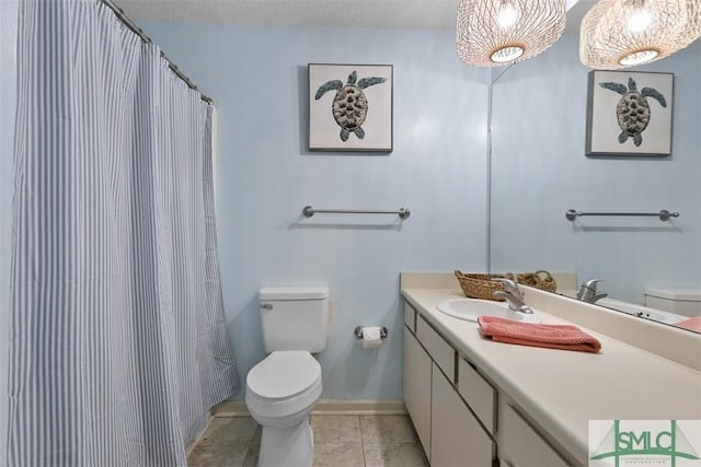 full bath with toilet, vanity, a textured ceiling, tile patterned flooring, and baseboards