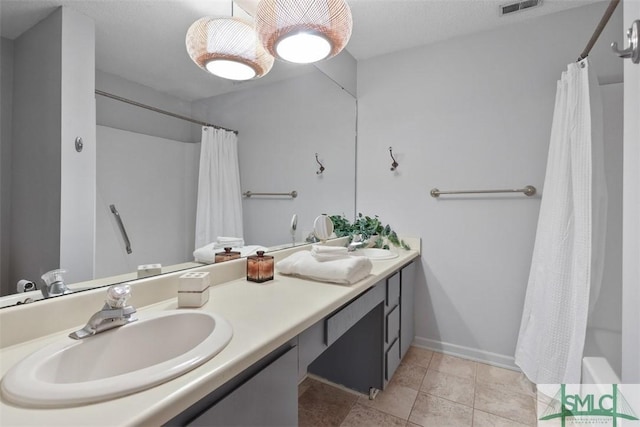 bathroom featuring tile patterned flooring, a shower with shower curtain, visible vents, vanity, and baseboards