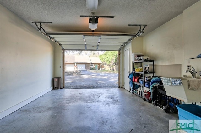 garage with a garage door opener and baseboards