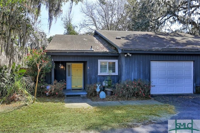 view of front facade with an attached garage and aphalt driveway