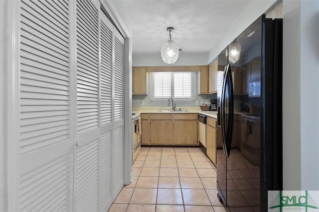 kitchen with black fridge with ice dispenser, dishwashing machine, light countertops, a sink, and light tile patterned flooring