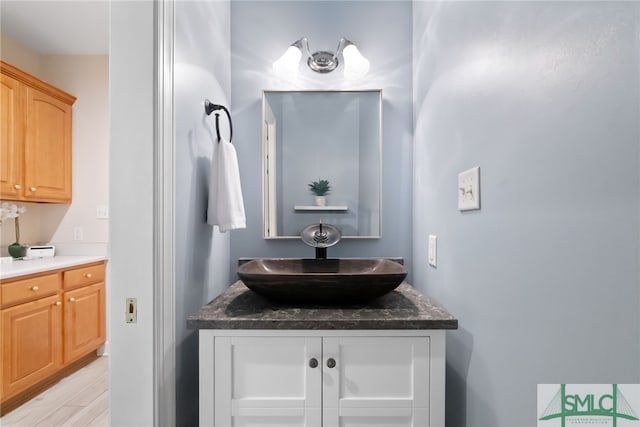 bathroom featuring vanity and wood finished floors